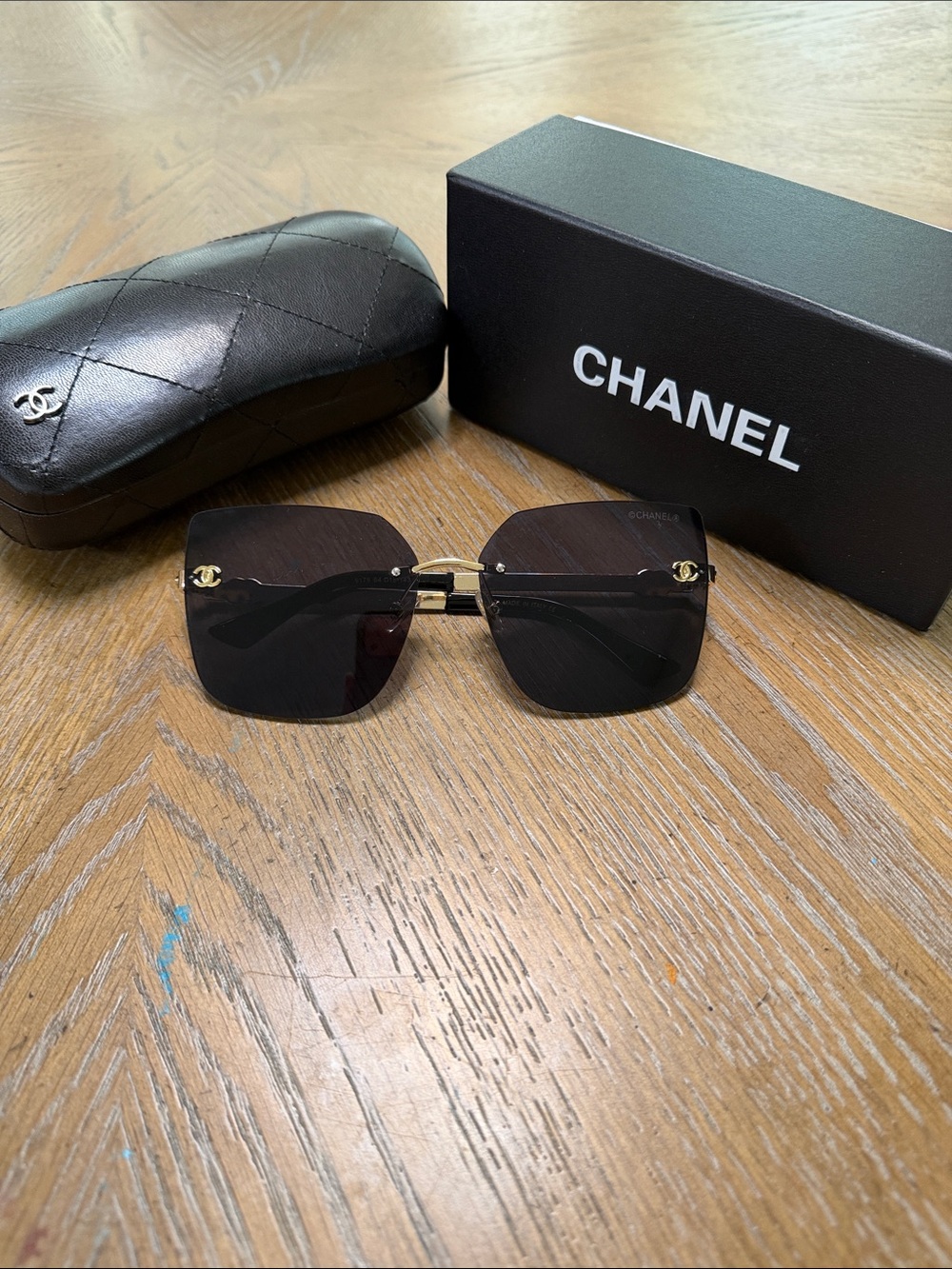 CHANEL Black Rimless Sunglasses with Gold Hardware